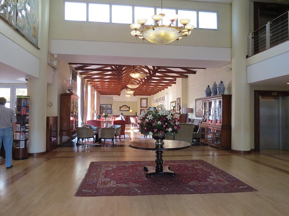 Spacious hotel lobby with elegant decor and furniture.