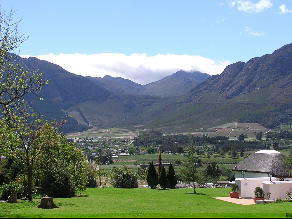 Scenic landscape with mountains and lush greenery.