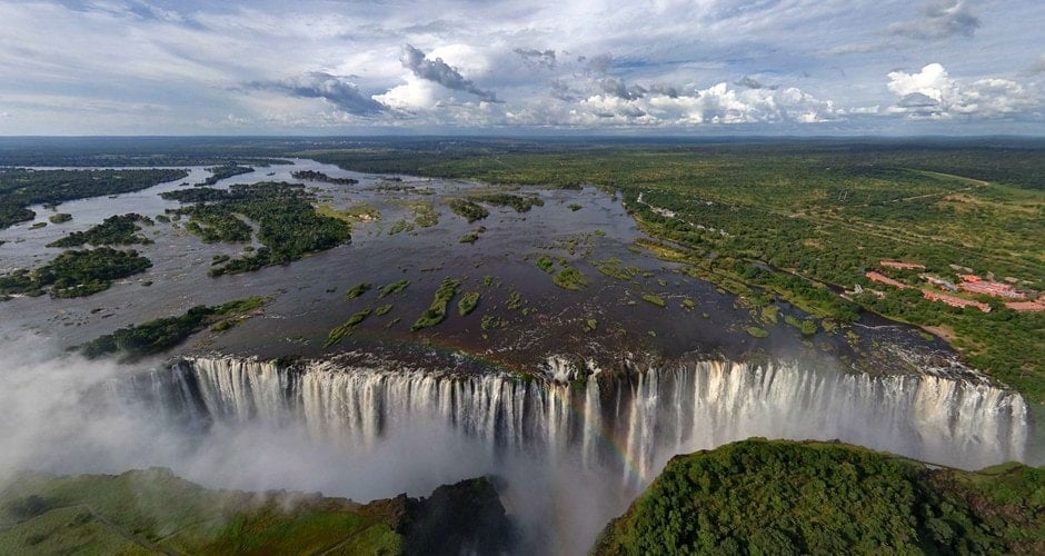 Aerial view of cascading waterfalls and lush landscape.