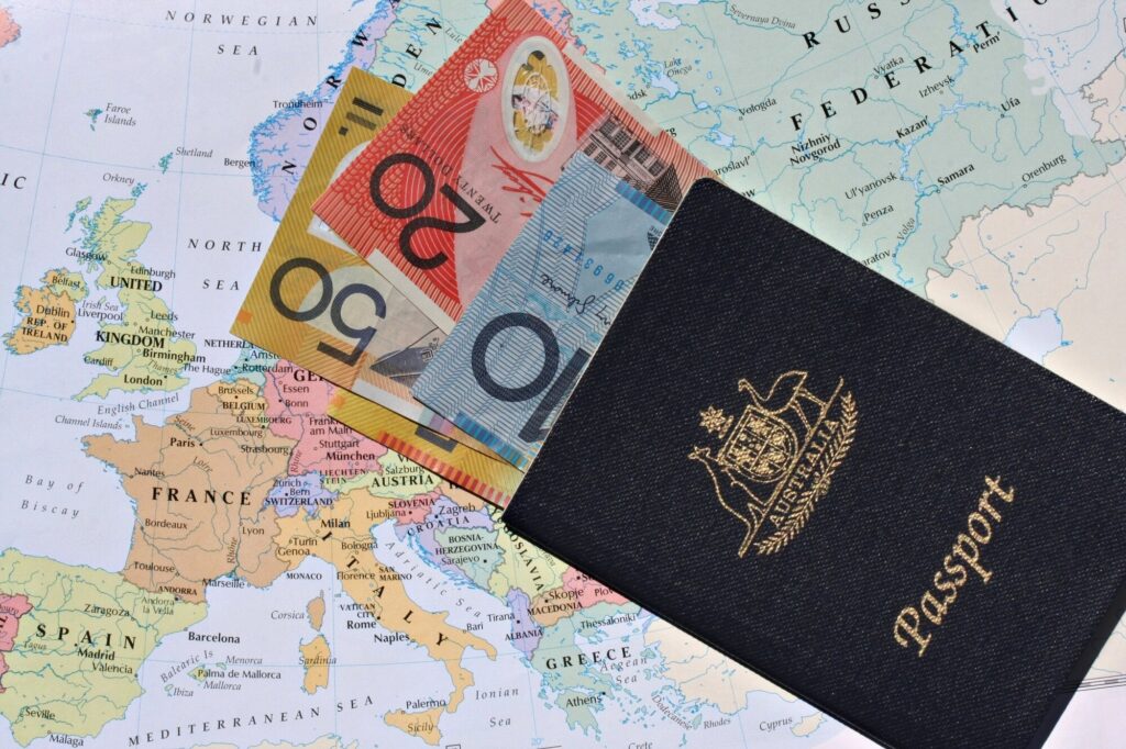 Australian passport alongside currency and map